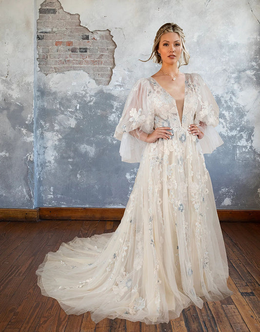 Robe de mariée à col en V profond avec dos nu, manches bouffantes et traîne ornée d'appliques